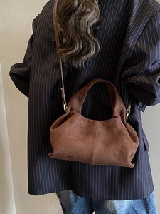 Brown suede bucket bag for women featuring a minimalist slouchy design for commuting