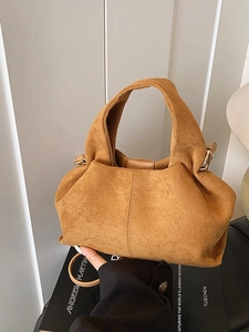 Fashionable camel suede bucket bag with elegant pleats and golden metal hardware