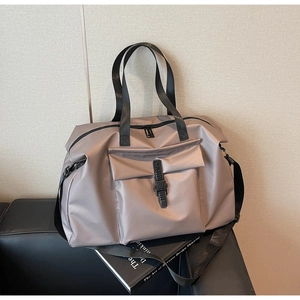 Macro detail of mauve travel bag with tactical buckle pocket and adjustable strap