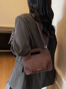 Dark brown suede bucket bag with top handle and gold hardware for commute outfits