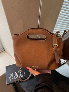 Brown frosted bucket bag with oval handle and adjustable shoulder strap for women