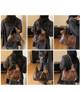 Detail view of versatile dark brown leather hobo bag with multiple zipper pockets