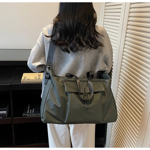 Macro detail of army green waterproof nylon travel bag with buckle and adjustable strap