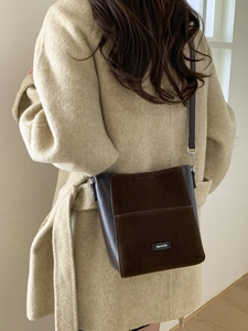 Brown vintage patchwork bucket bag with suede texture and adjustable shoulder strap