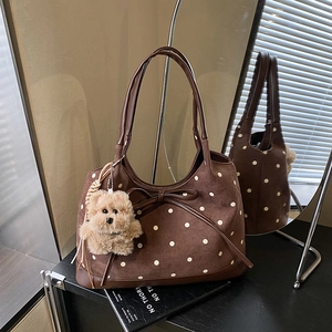 Dettaglio della borsa tote vintage in pelle scamosciata marrone con pois e fiocco