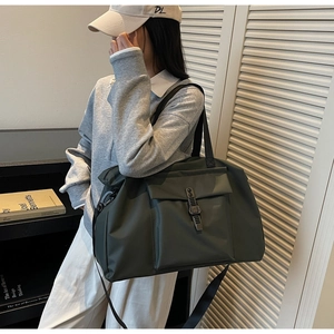 Detail of olive green large capacity travel bag with metallic buckle closure