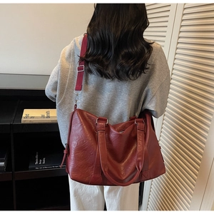 Deep red large tote bag with adjustable strap shown from a back-view perspective