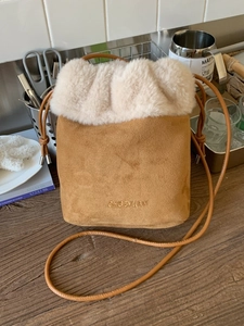 Brown suede drawstring bucket bag with cream faux fur trim and embroidery for autumn