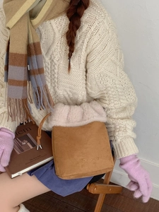 Vintage suede bucket bag with pink faux fur trim and adjustable drawstring strap