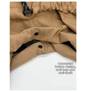 Detail of drawstring crossbody bag showing secure snap button closure and durable fabric