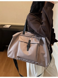 Large gray-purple nylon travel bag with adjustable strap and buckle front pocket