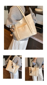 Detail view of large cream tote bag with stylish buckle pocket and cute bunny charm