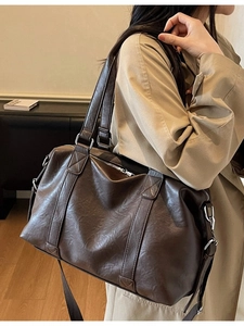 Deep brown leather Boston travel bag with silver zippers and large capacity