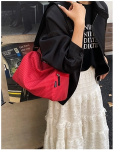 Detail of red and white checkered pattern on a versatile crossbody pillow bag for women