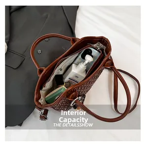 Internal view of brown woven bucket bag showing spacious storage with zipper closure