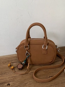 Elegant brown matte Boston shoulder bag with vintage charm and floral charm detail