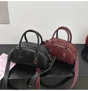 Litchi texture leather bowling bags in black and burgundy with contrast stitching details