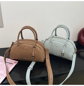 Brown and light blue pebble leather Boston bags with top handles and shoulder straps