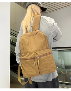 Detail of water-resistant mustard yellow backpack with multi-pocket functional design
