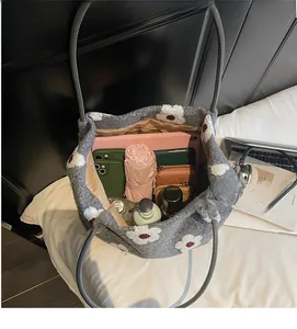 Spacious interior of grey plush floral tote bag holding tablet, umbrella and daily essentials