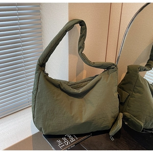 Detail der olivgrünen Hobo-Tasche aus gewaschenem Nylon mit breitem Gurt und Seitentasche