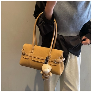 Détail du sac Boston en simili cuir marron avec charm ours en peluche et boucles