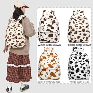 Detail view of plush cow print backpacks in four colors including brown and orange accents
