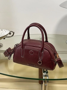 Classic dark burgundy leather bowling handbag with white contrast stitching and top handles
