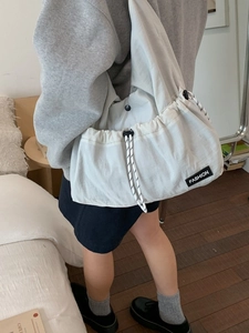 Minimalist beige drawstring tote bag with Fashion patch shown in a lifestyle home setting