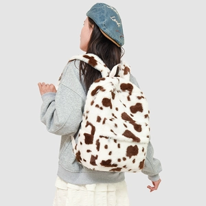 Detailed view of plush faux fur backpack with stylish cow print texture and fluffy straps