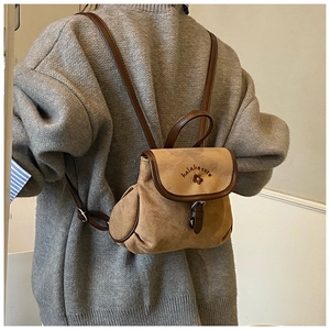 Detail of vintage matte bucket backpack with flower embroidery and metal buckle