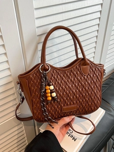 Brown woven texture bucket bag with dual handles and adjustable shoulder strap