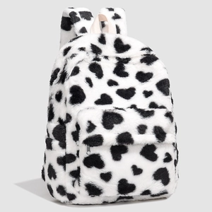 Close-up detail of plush heart pattern backpack with soft texture and front zipper pocket