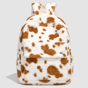 Close-up of soft cow print plush backpack featuring fuzzy texture and sturdy zipper detail