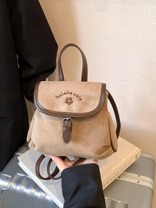 Vintage khaki suede bucket backpack with brown leather trim and floral embroidery