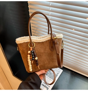 Sac seau en daim marron avec bordure en polaire blanche et détail de pompon en bois