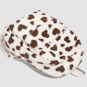 Detailed view of the fuzzy cow print heart pattern backpack with plush faux fur texture