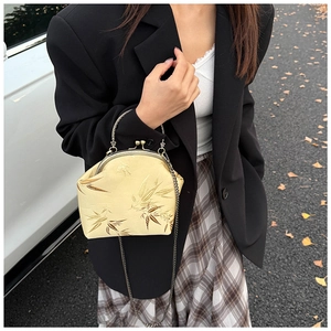 Detail of champagne gold chain shell bag featuring elegant bamboo jacquard embroidery