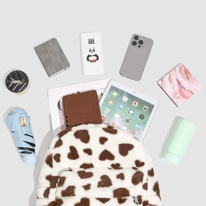 Layout showing plush backpack capacity with tablet, umbrella, and daily essentials