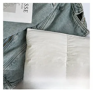 Close-up of white quilted fabric texture with premium stitching detail on bag
