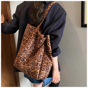 Detail view of large leopard print tote bag with soft texture and sturdy shoulder strap