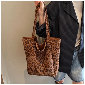 Detail of soft leopard print tote bag texture and large capacity fit on shoulder