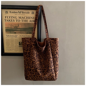 Detailed close-up showing the soft suede texture and classic leopard print on this tote bag