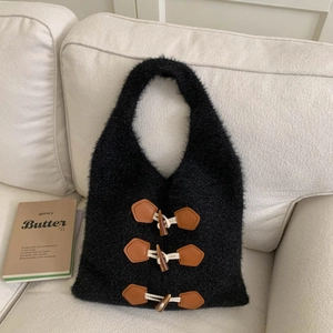 Close-up of black fuzzy knit tote bag featuring retro brown leather toggle button details