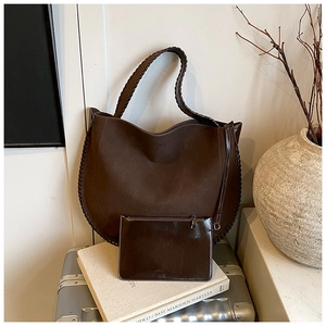 Detail of vintage large brown suede tote bag with woven trim and matching inner pouch
