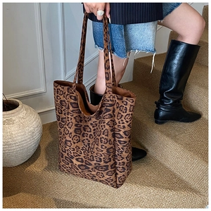 Close-up of leopard print large tote bag with textured fabric and durable shoulder straps