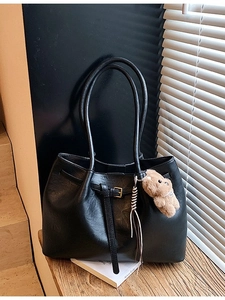 Large black leather tote bag with a cute bear charm and adjustable shoulder strap
