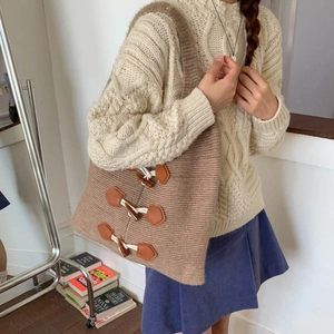 Detail of vintage knit tote bag featuring large wooden toggle buttons and thick wool texture