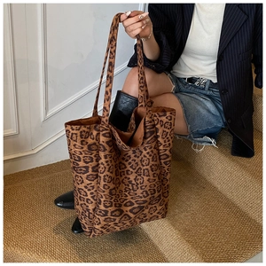 Detail shot of the spacious leopard print tote bag texture and soft drape on stairs