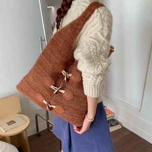 Close-up of brown knit tote bag featuring retro horn buttons and leather patches